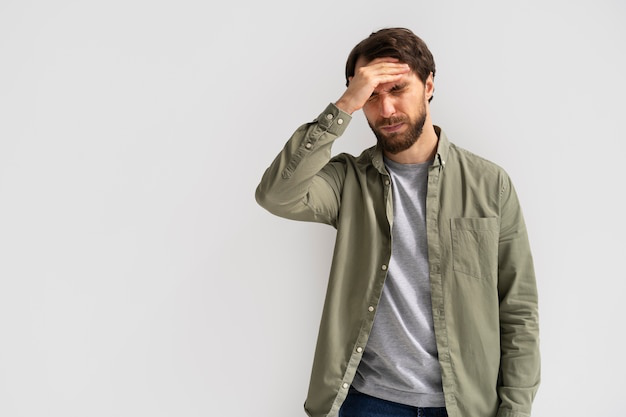 Man touching his head, reflecting fatigue and decreased energy.