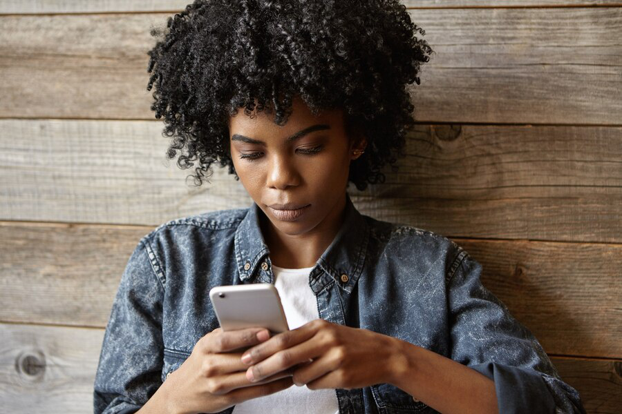 A woman uses her phone