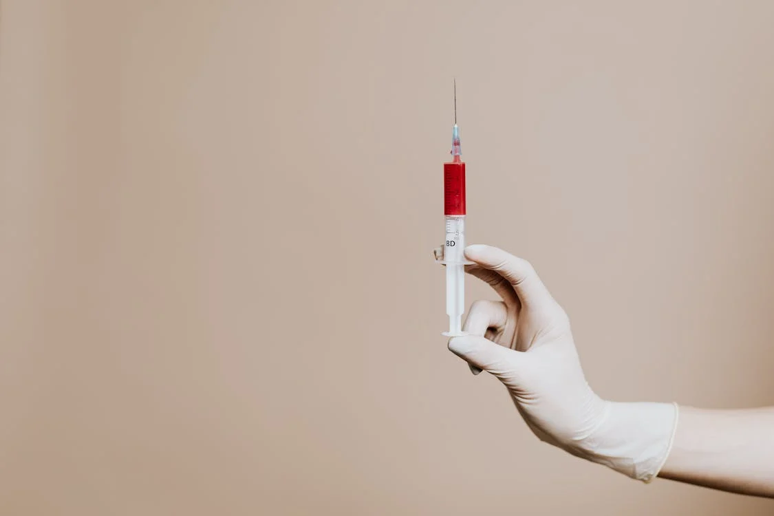 A person holding a syringe 