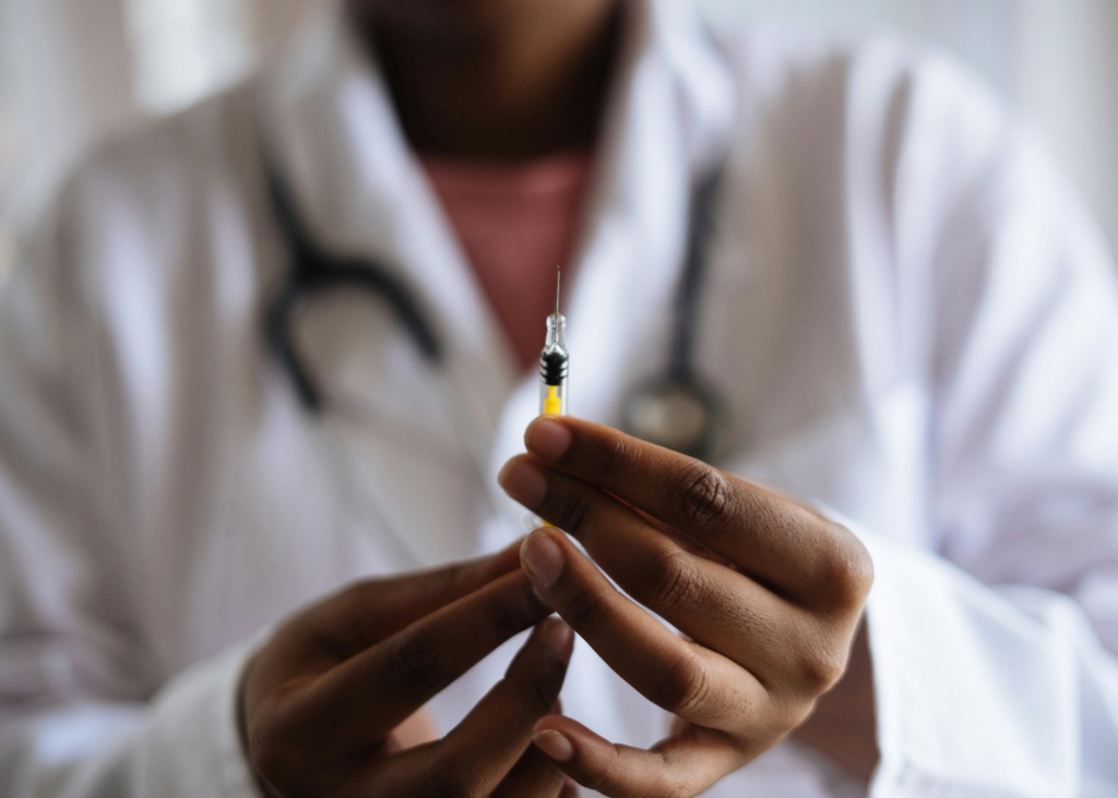 A close-up of a person’s hands holding an injection showcasing how weight loss peptides are administered