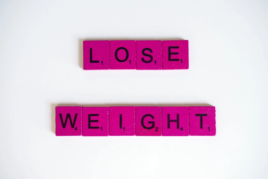 Scrabble tiles with a loose weight text 