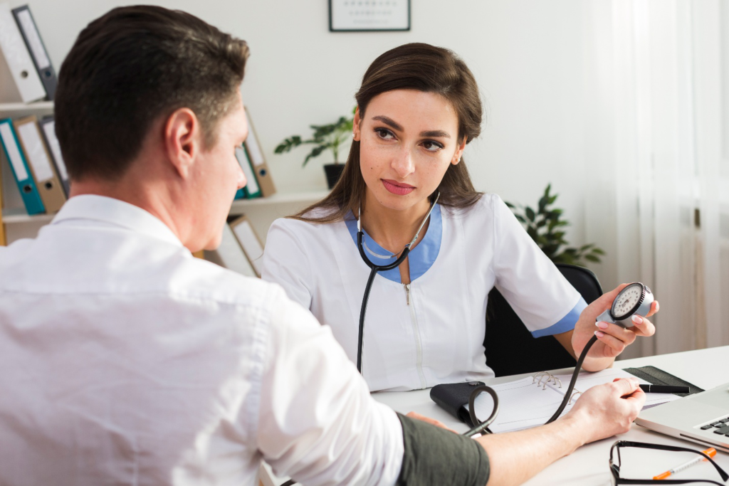 A healthcare professional checking a patient’s blood pressure during a consultation.