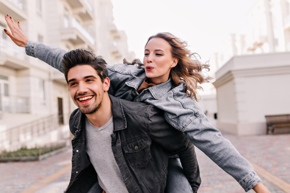 A joyful couple outdoors, symbolizing the benefits of hormone therapy in restoring balance and energy.