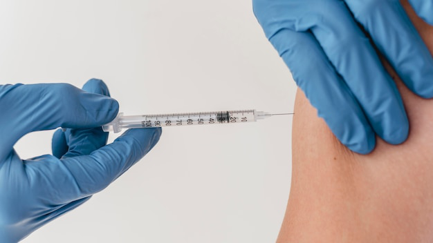 A healthcare provider administering an injection into a patient’s arm.