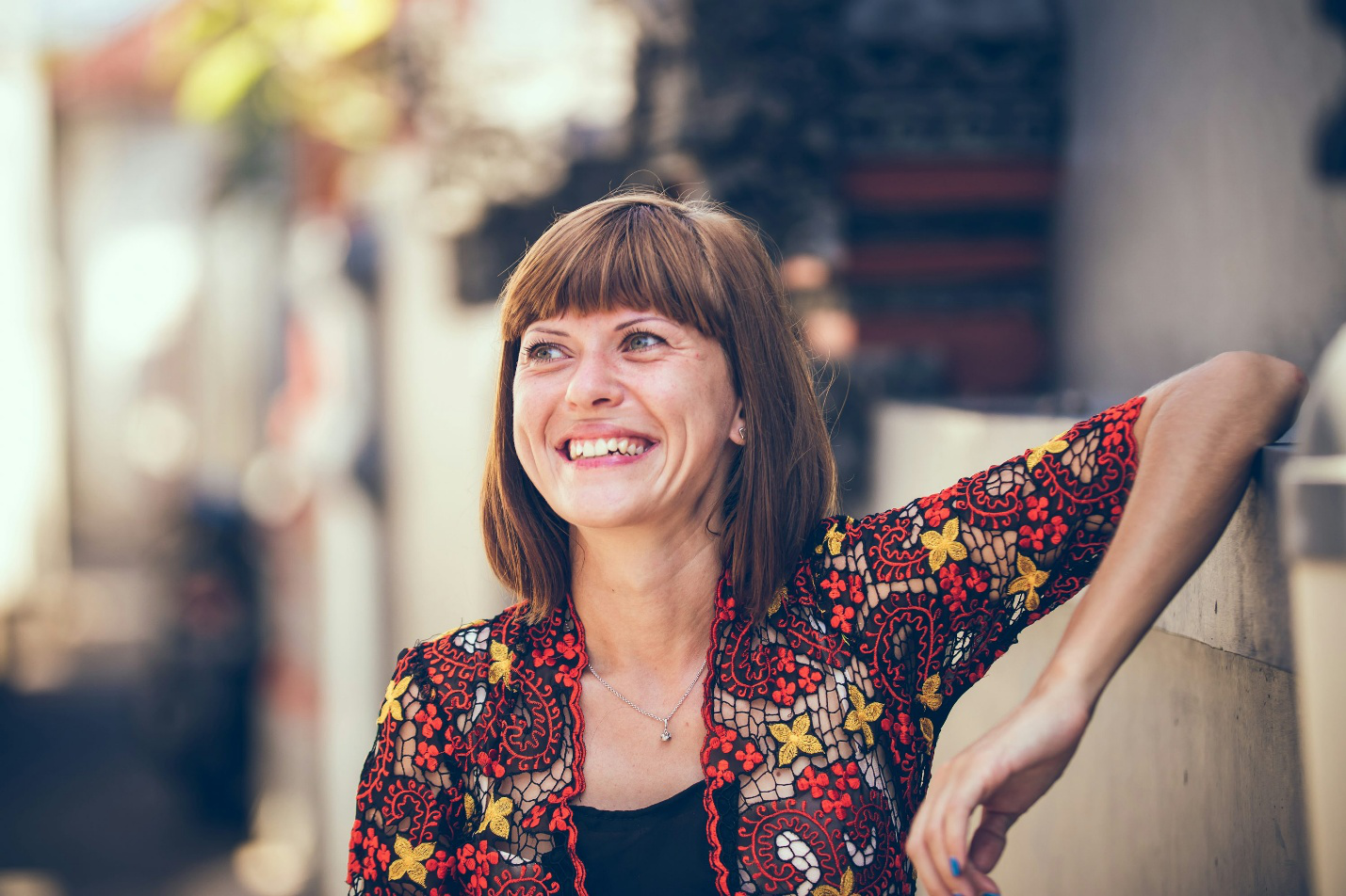 A smiling woman radiating energy and vitality.