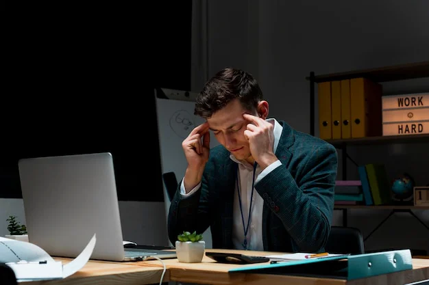 A man looking stressed at work.