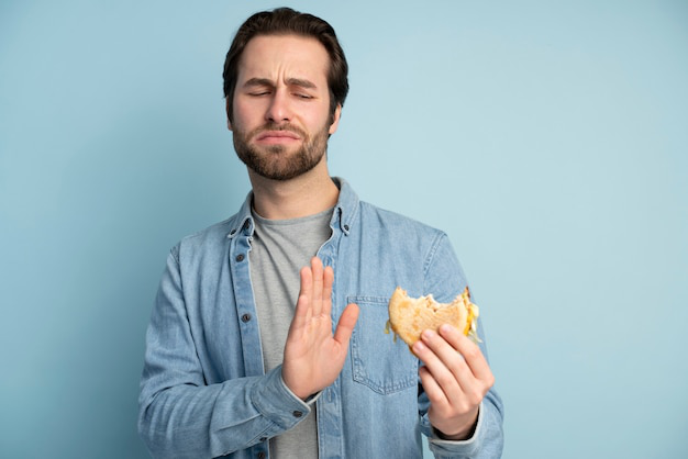 Man refusing food with a full expression
