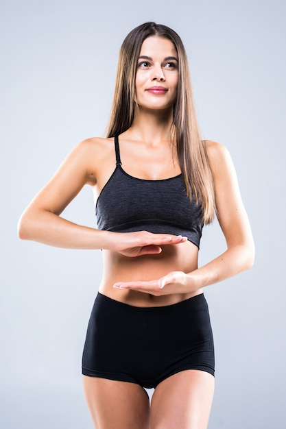 Woman signaling her midsection to represent gut health focus