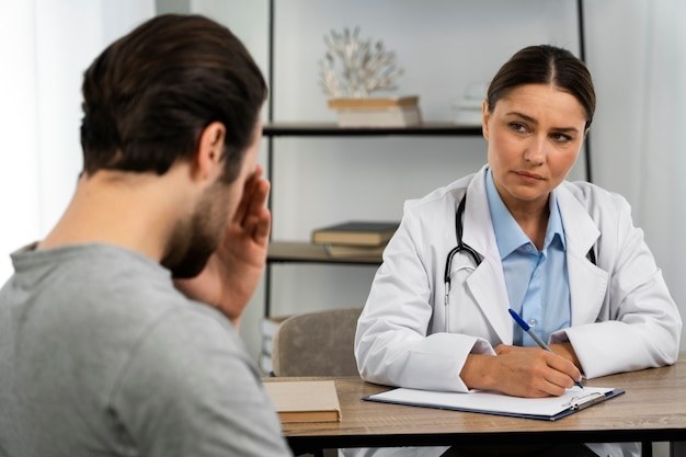 A man consulting with a female doctor about hormone therapy