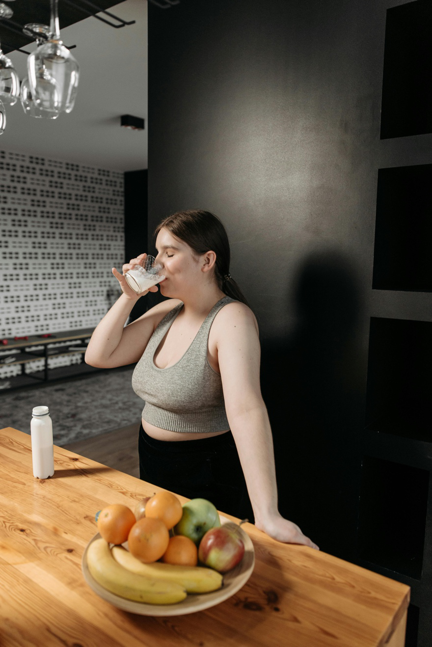 A woman is drinking a smoothie
