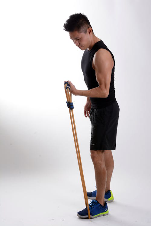 Man doing resistance band workout to support muscle mass and metabolism