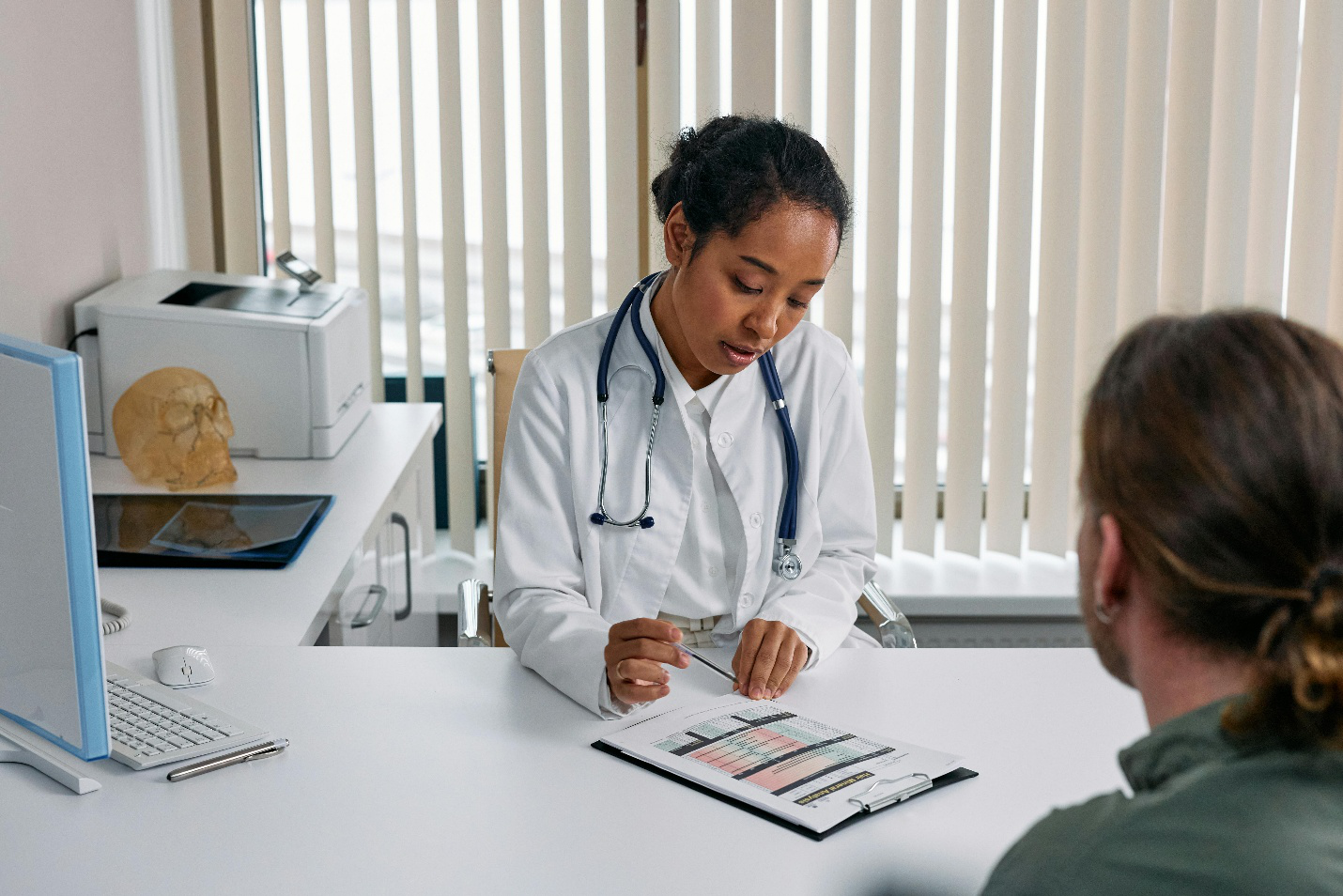 Female doctor reviewing lab results with male patient during a low testosterone consultation