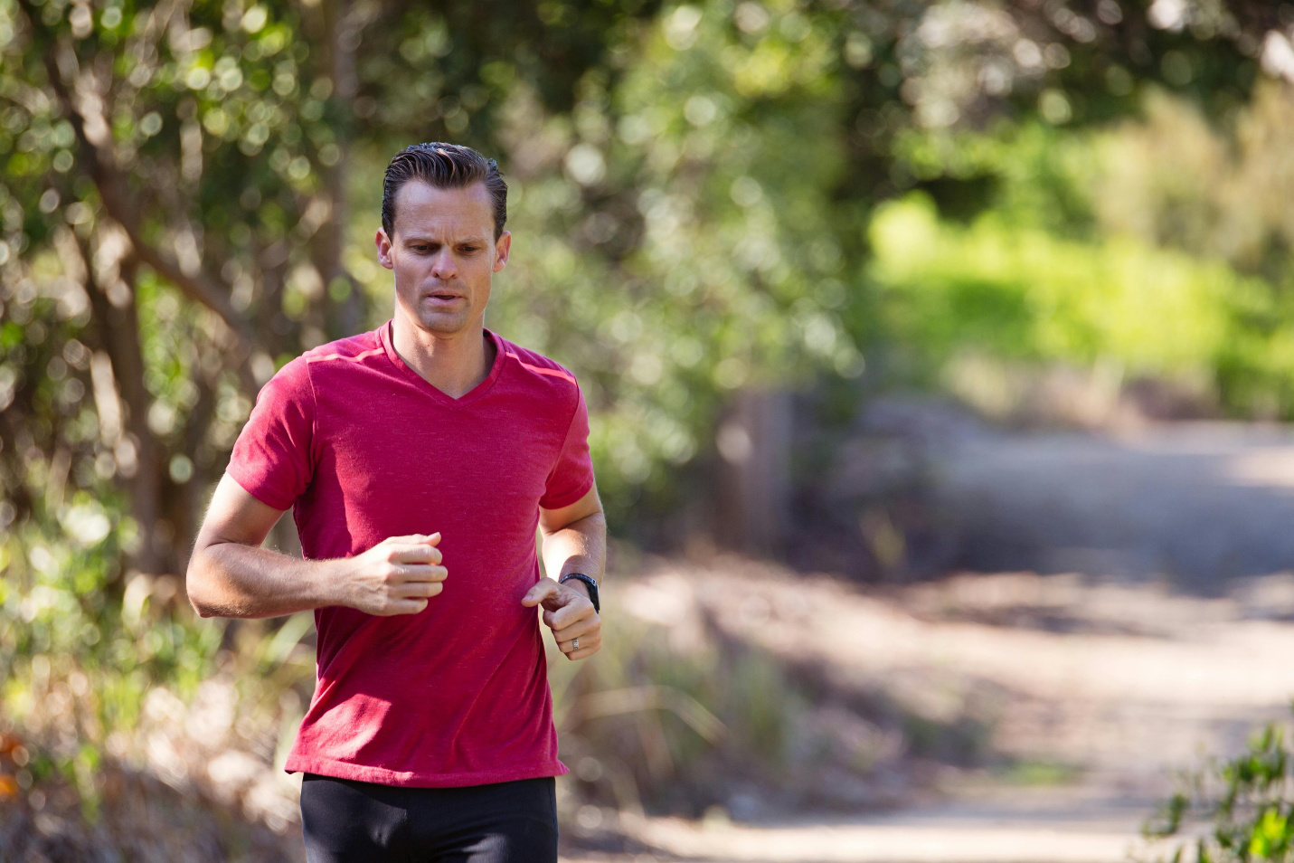 Man running on an outdoor path with healthy energy and stamina