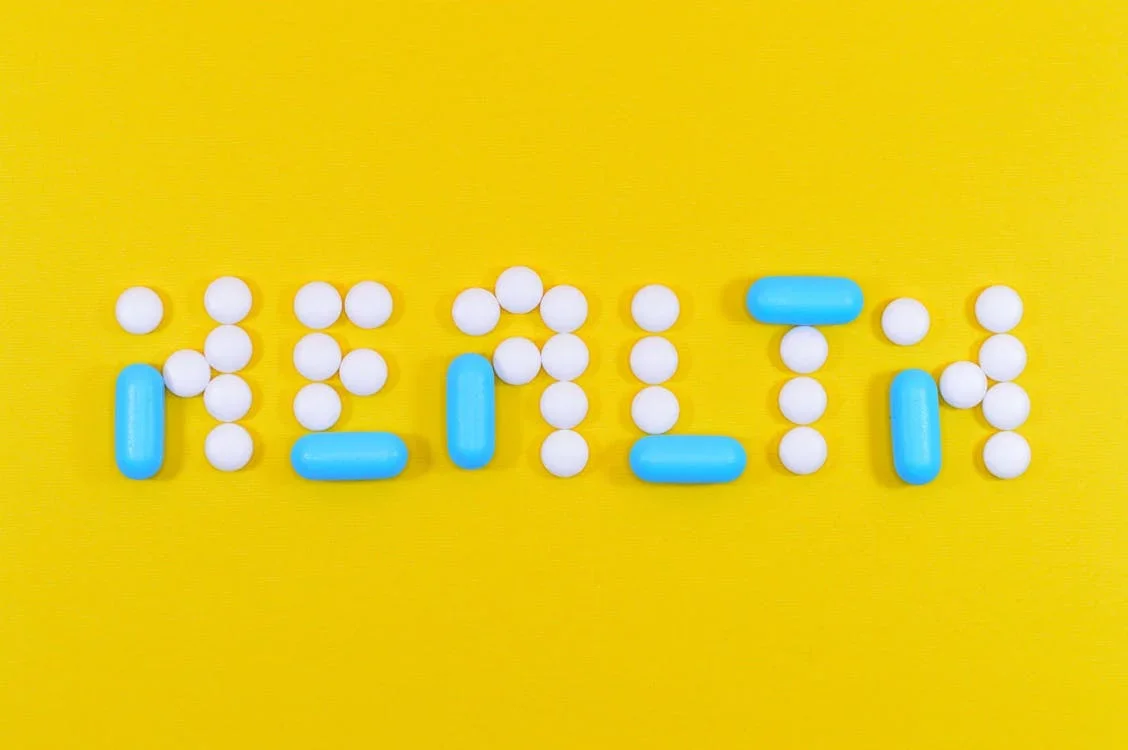 An image of the word health written using blue and white pills