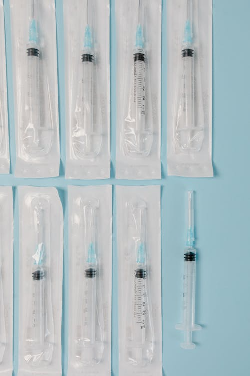 An image of syringes on a blue surface    