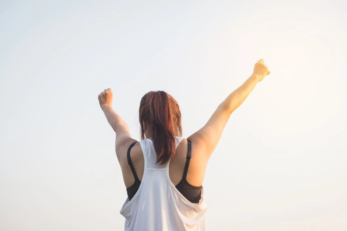  An image of a woman raising her hands toward the sky  