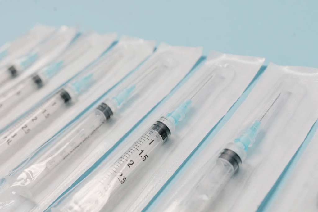 an image of packed syringes on a blue surface 