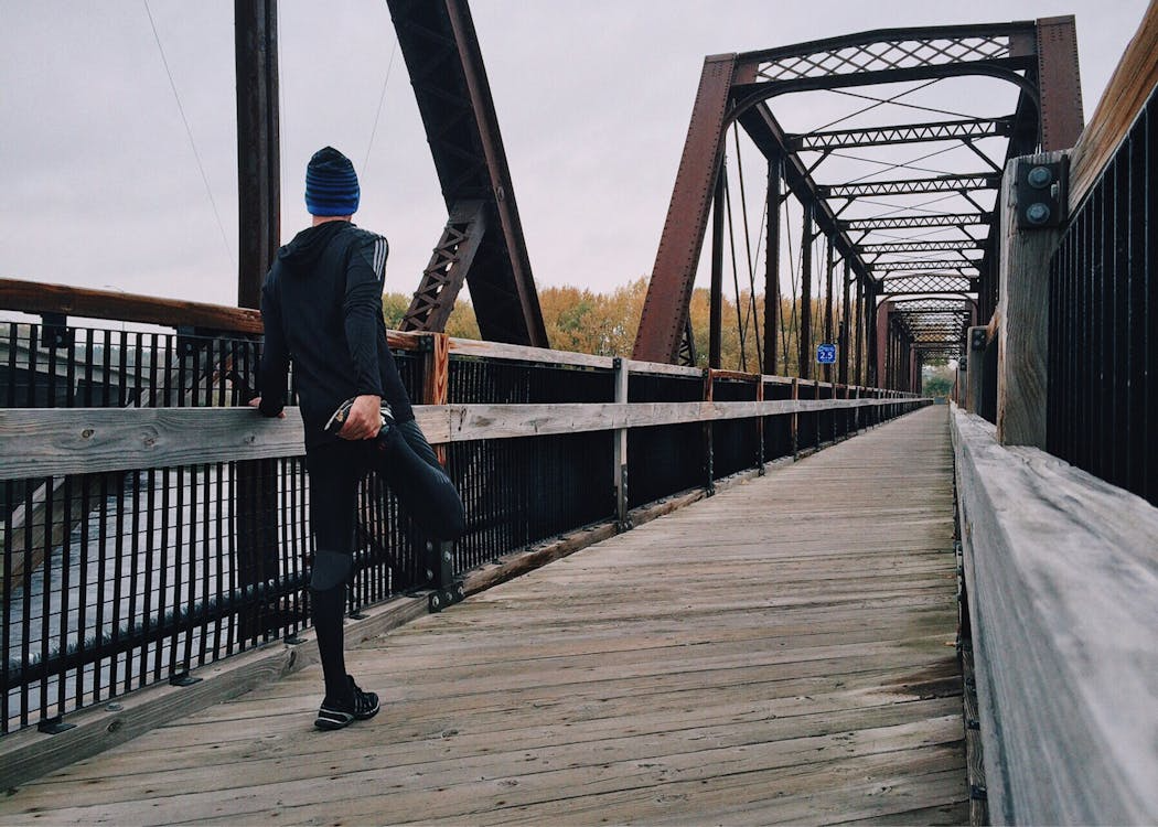 An image of a man standing on a bridge      