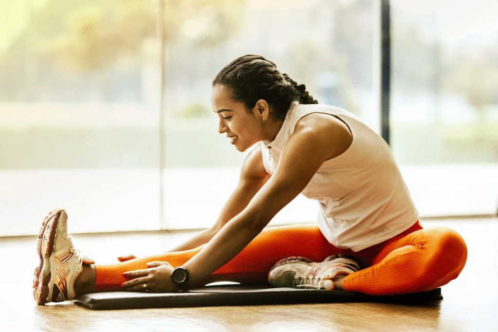 An image of a woman stretching  on the ground  