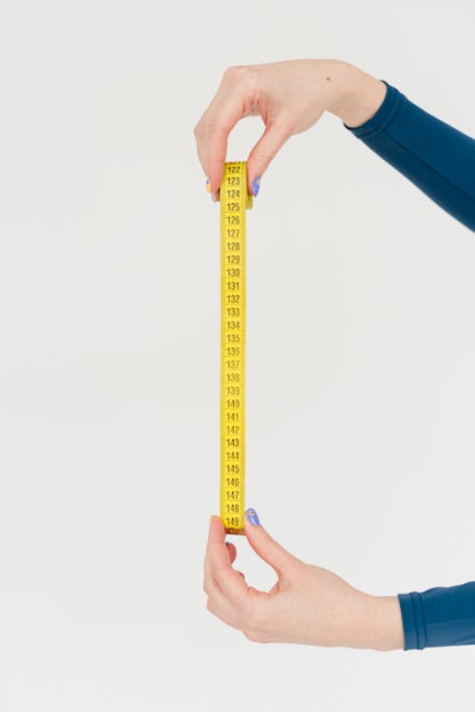 An image of a person holding a measuring tape