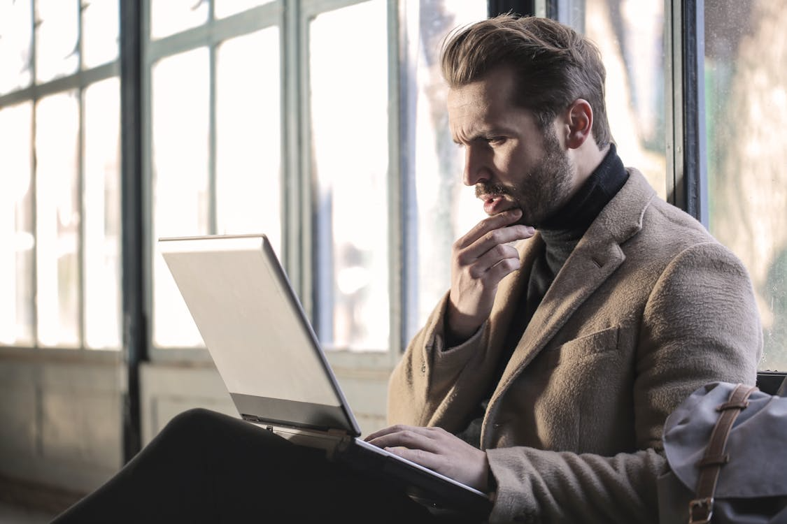 An image of a man working on a laptop