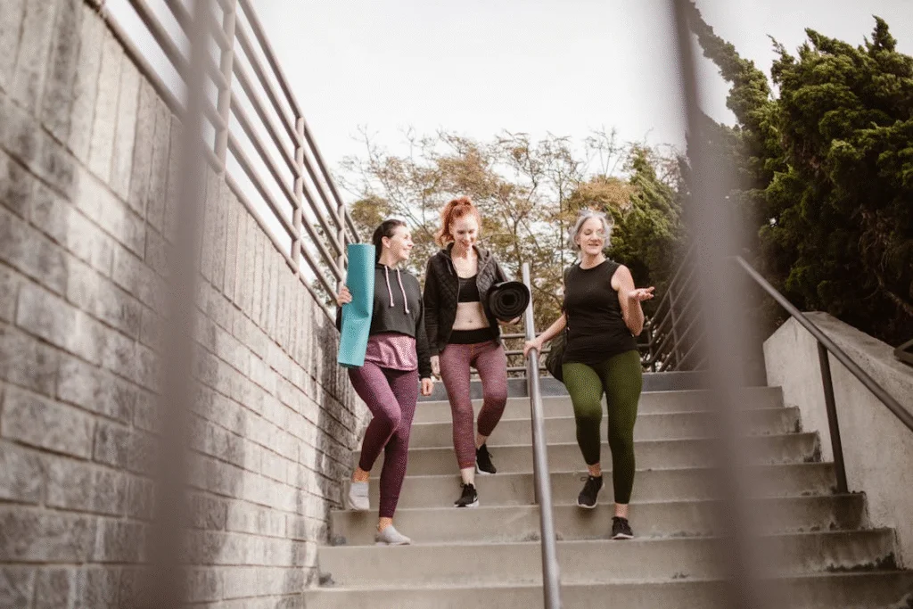 An image of three women walking down the stairs