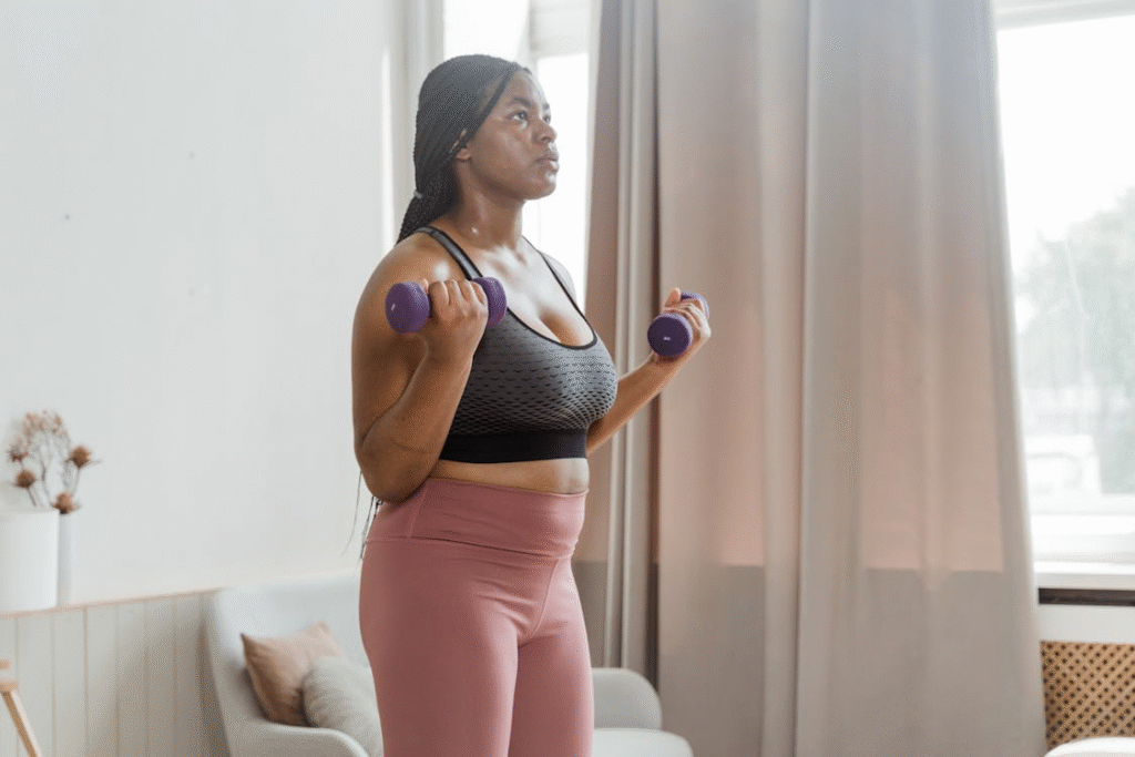 a woman lifting weights at home.