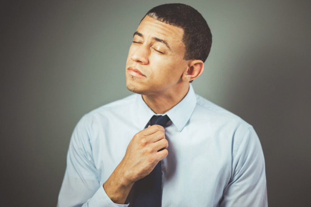 An image of a man arranging his tie