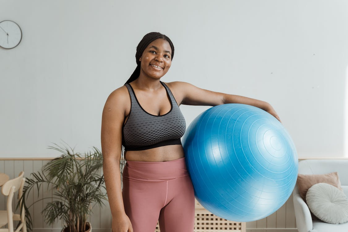 a woman holding an exercise ball.
