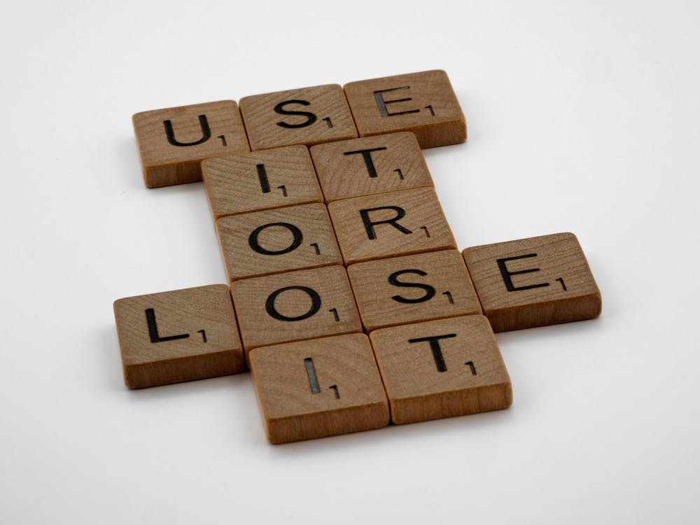 An image of wooden Scrabble tiles on a white surface
