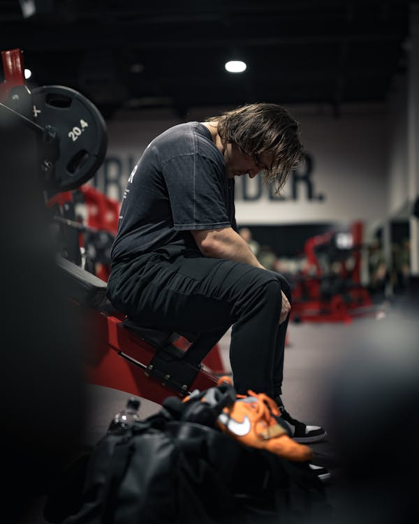 An image of a man sitting during training in the gym  