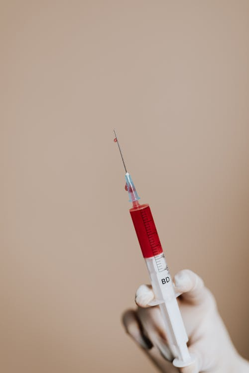 An image of a person holding a Lipo-C injection