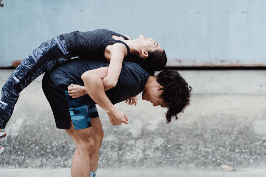 An image of a woman and a man exercising together  