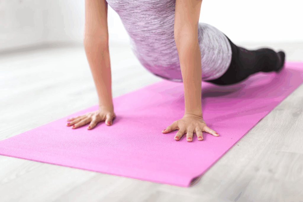 An image of a woman exercising on her yoga mat