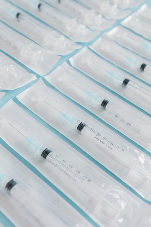 An image of syringes on a blue surface