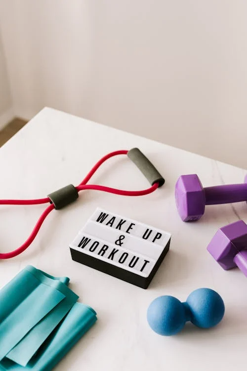 An image of a wake-up and workout slogan on a light box, among other sports equipment