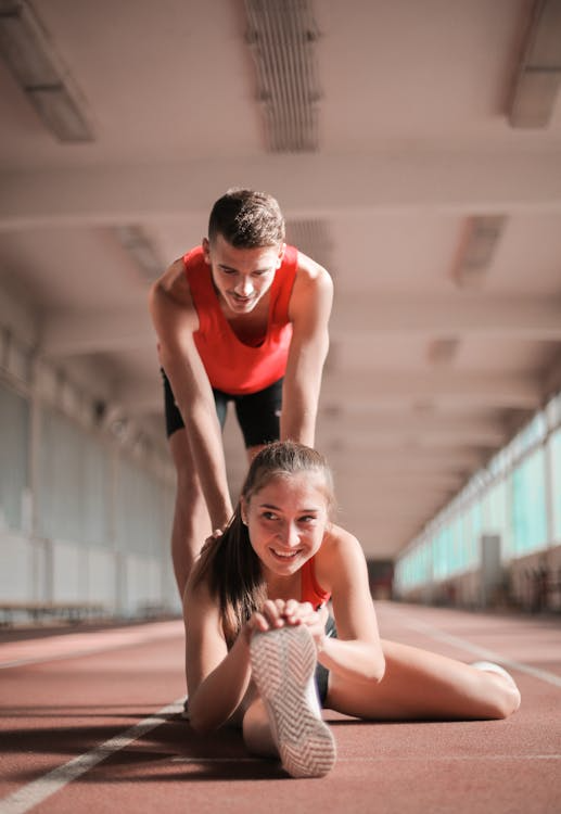 An image of a woman and a man exercising together