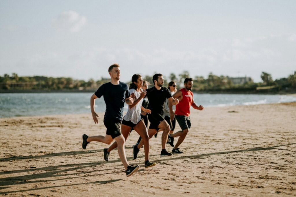 men-and-women-running-on-sea-shore