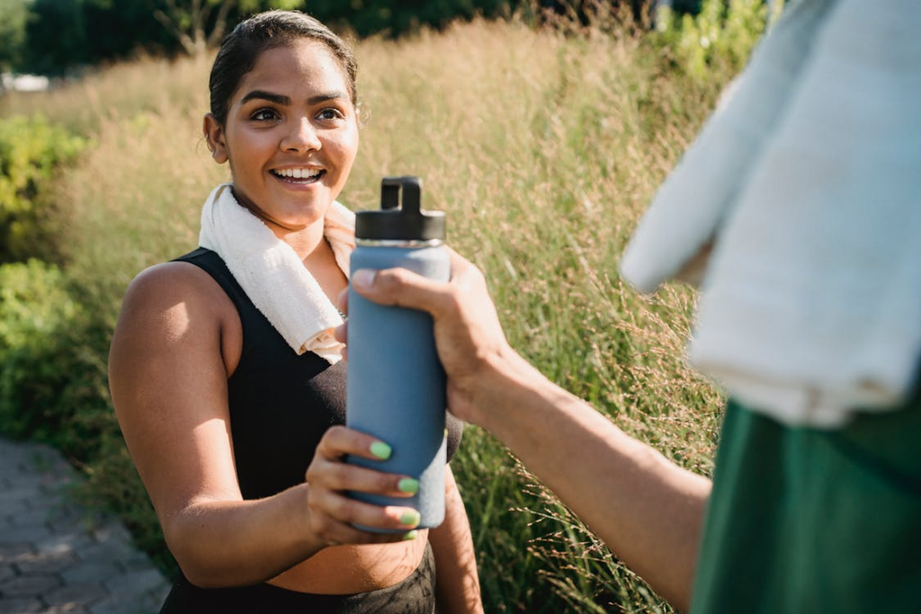 An image of a woman holding a water bottle