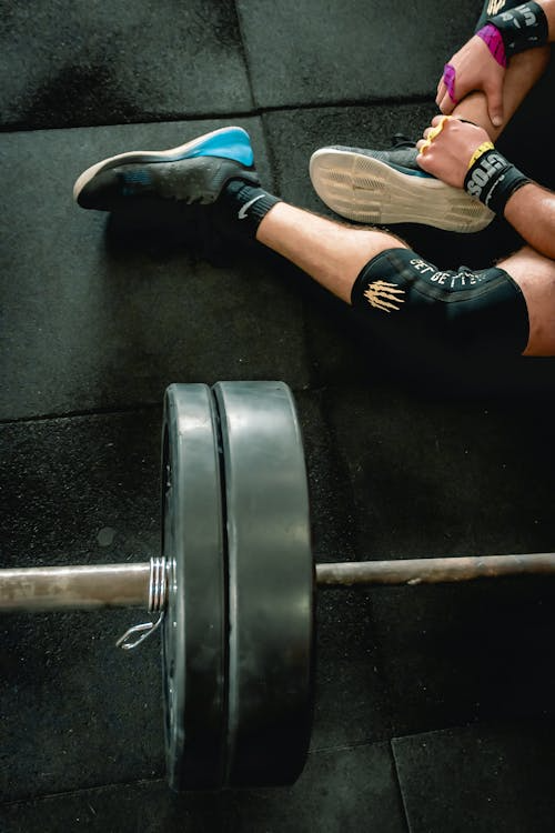 An image of a person sitting beside a barbell