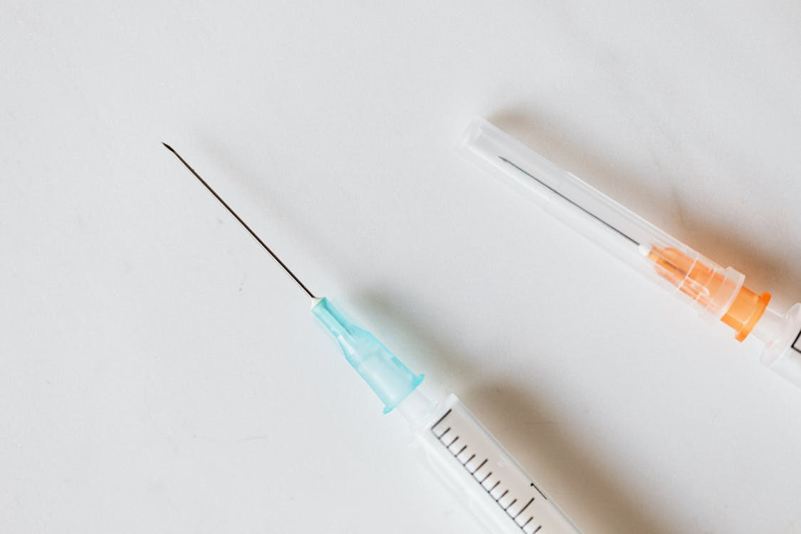 An image of syringes on a white surface