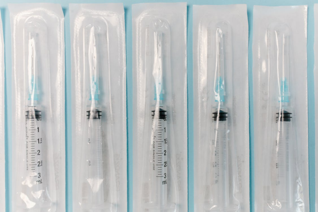 An image of packs of syringes on a blue surface       