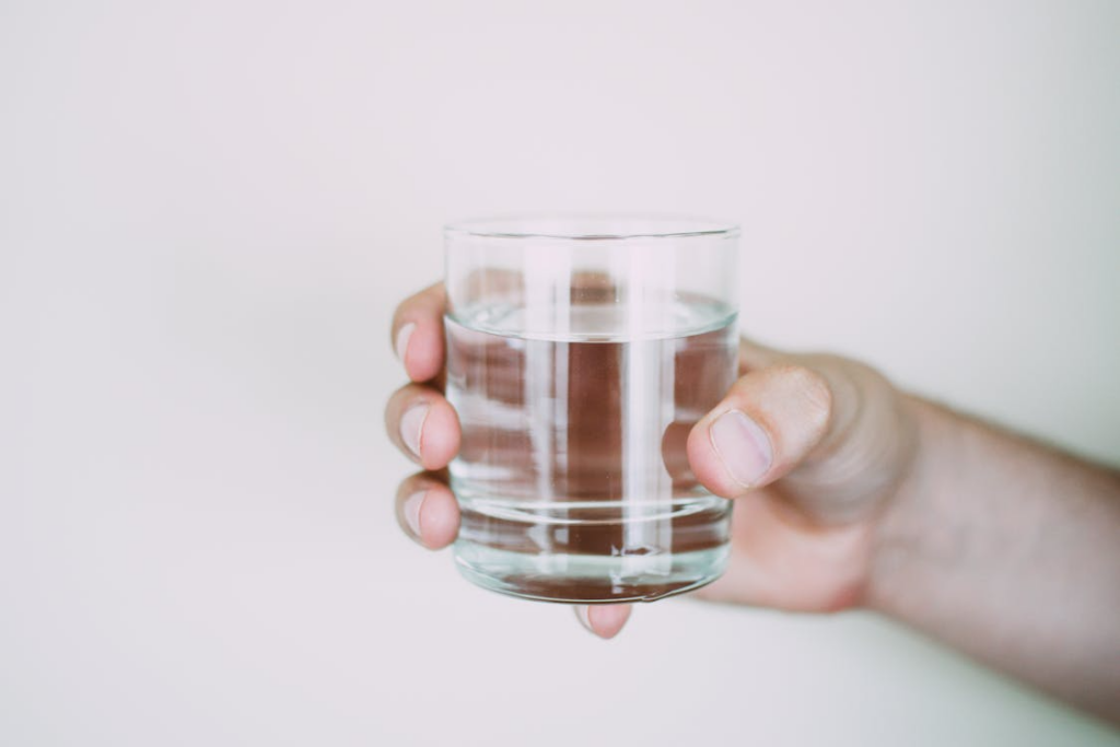  An image of a person holding a glass of water        