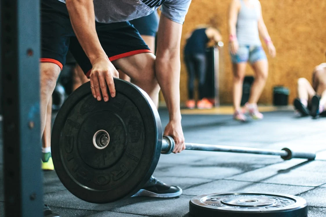 An image of a man holding a barbell
