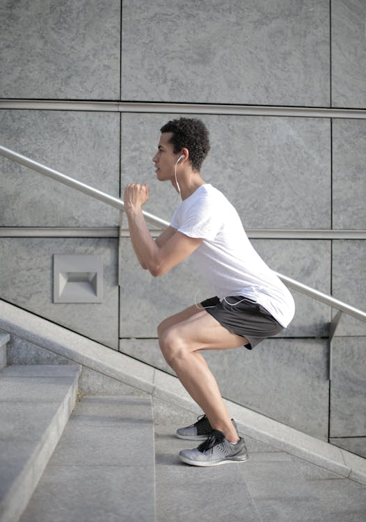 An image of a man exercising on the stairs