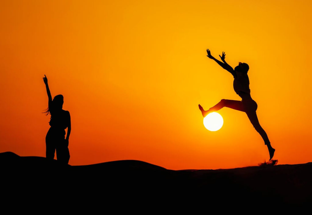 Two people jumping around energetically