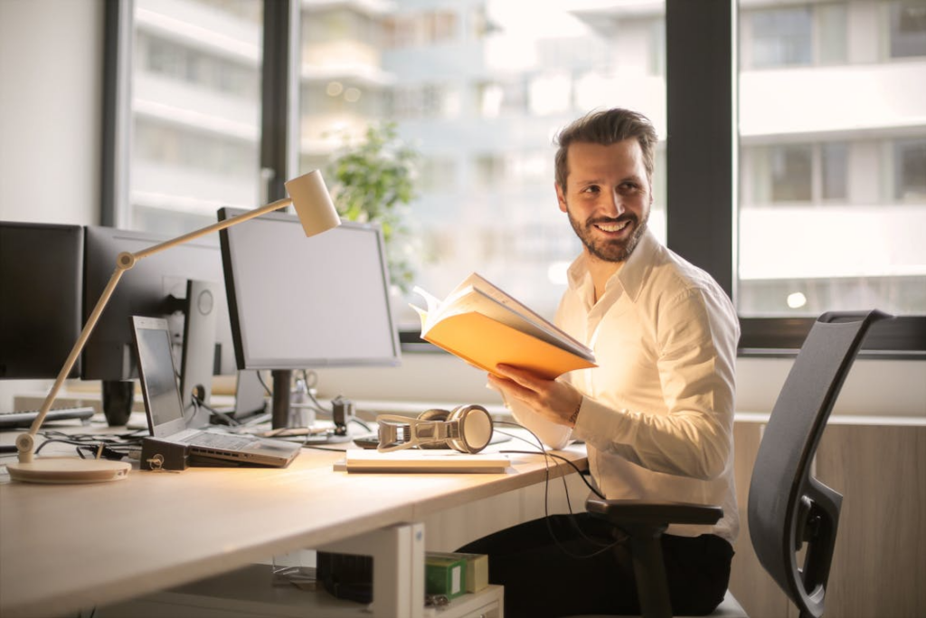 Man sitting and reading a book in a calm environment