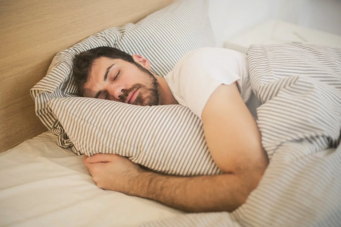 Man lying down asleep in a bedroom