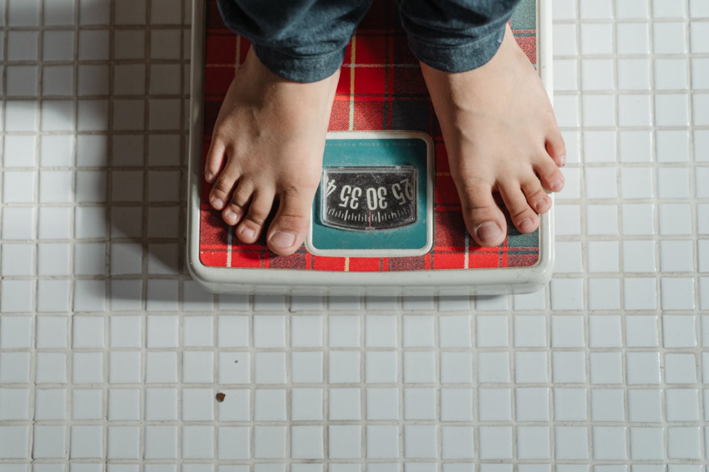  Child standing on a weighing scale