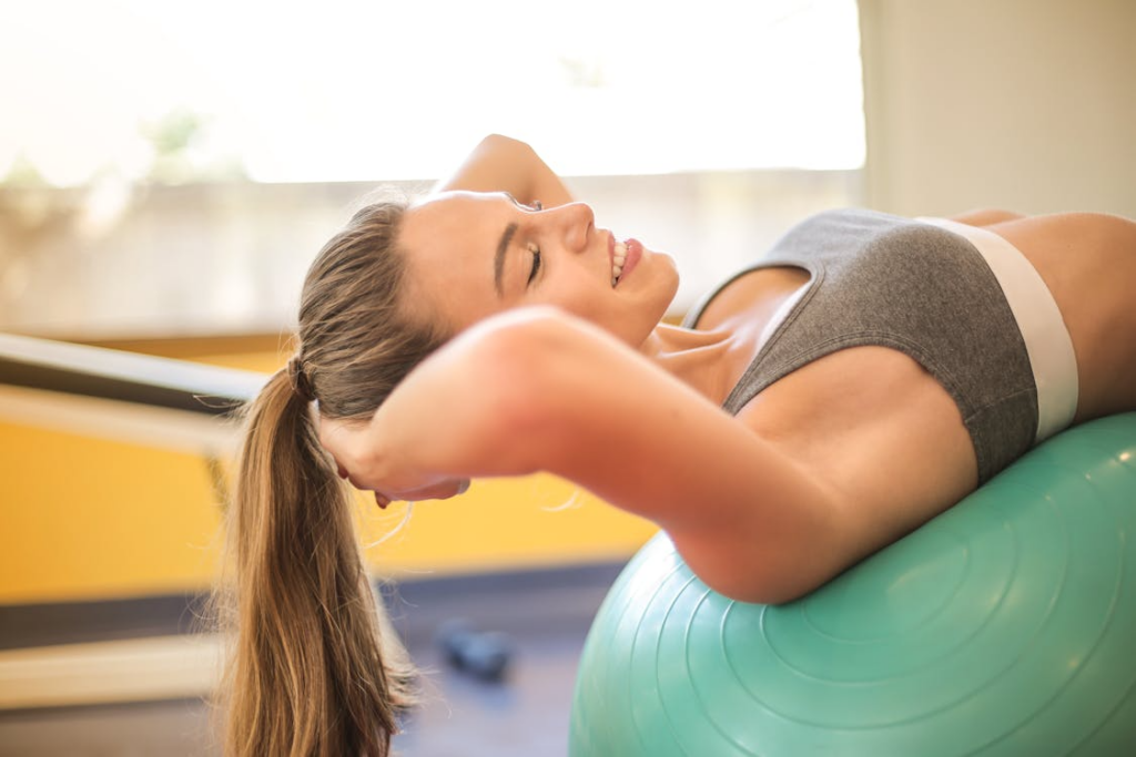 An image of a woman leaning on a ball  
